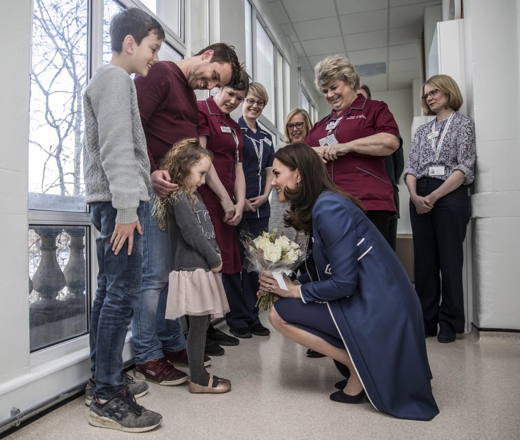 Kate's growing belly didn't stop her from kneeling down to greet 5-year-old Bella Kedwell-Parsons at the children's ward at St. Thomas's Hospital in London in February 2018.