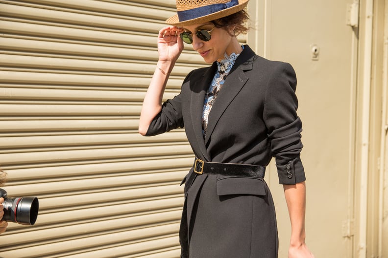 A Blazer Cinched at the Waist With a High-Neck Lace Top and Hat