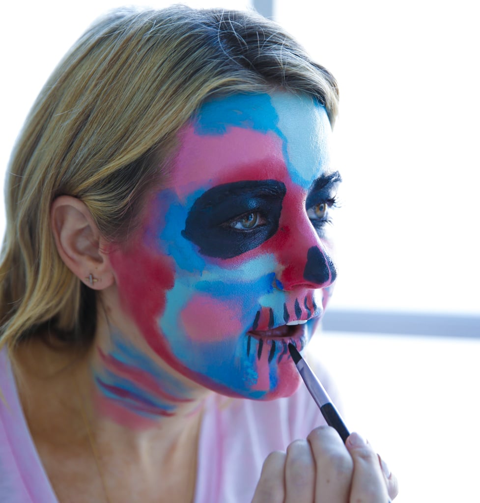 Then, extend vertical lines on your lips, which will ultimately create the shape of the teeth. Fill in between your lips with black as well.