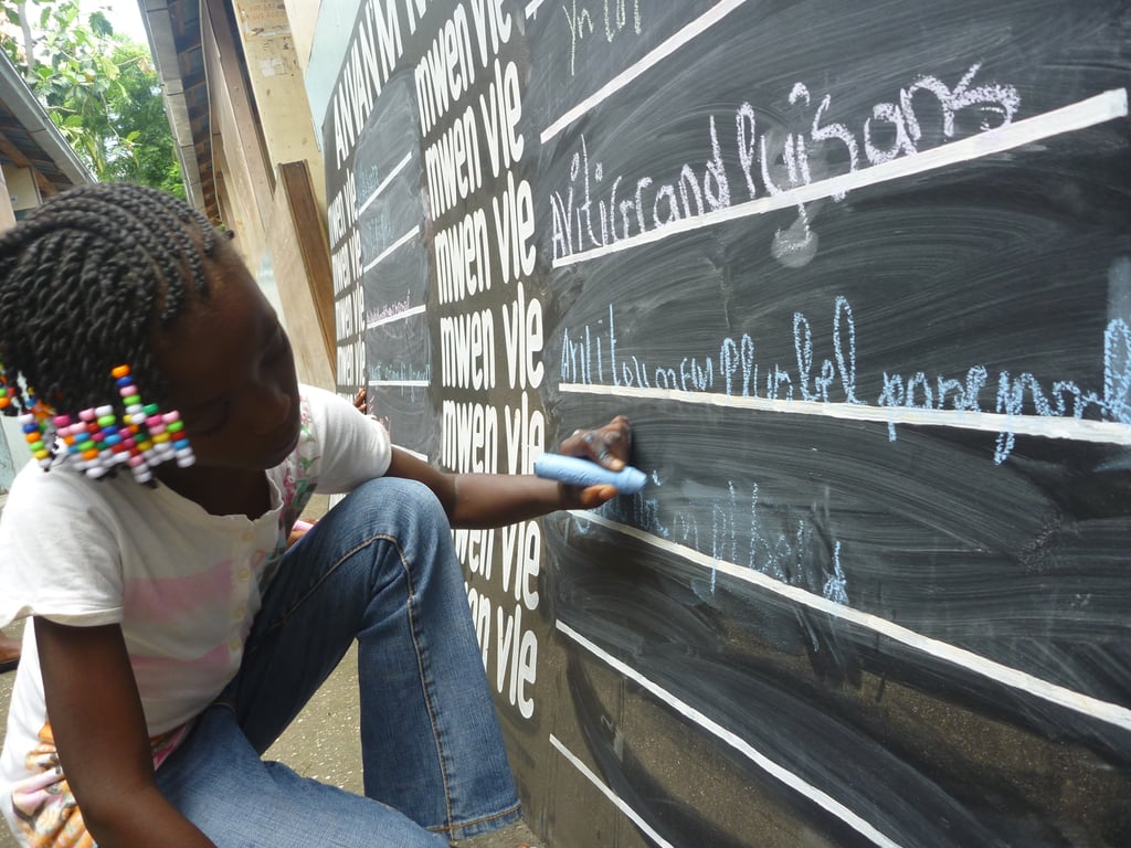 A young girl in Léogane, Haiti, wrote on a "Before I Die" blackboard, where entries from other children included "to be president" and "to make a difference in the lives of others."
Photo courtesy of BeforeIDie.com