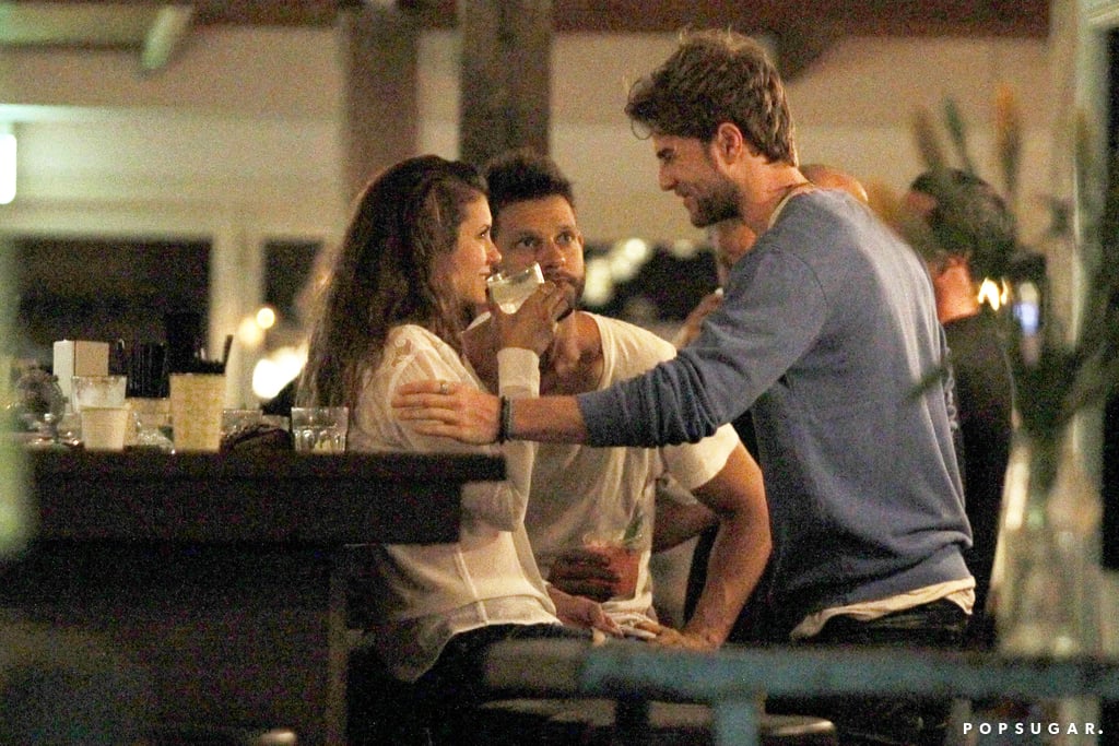 Nathaniel touched Nina's arm at the bar.