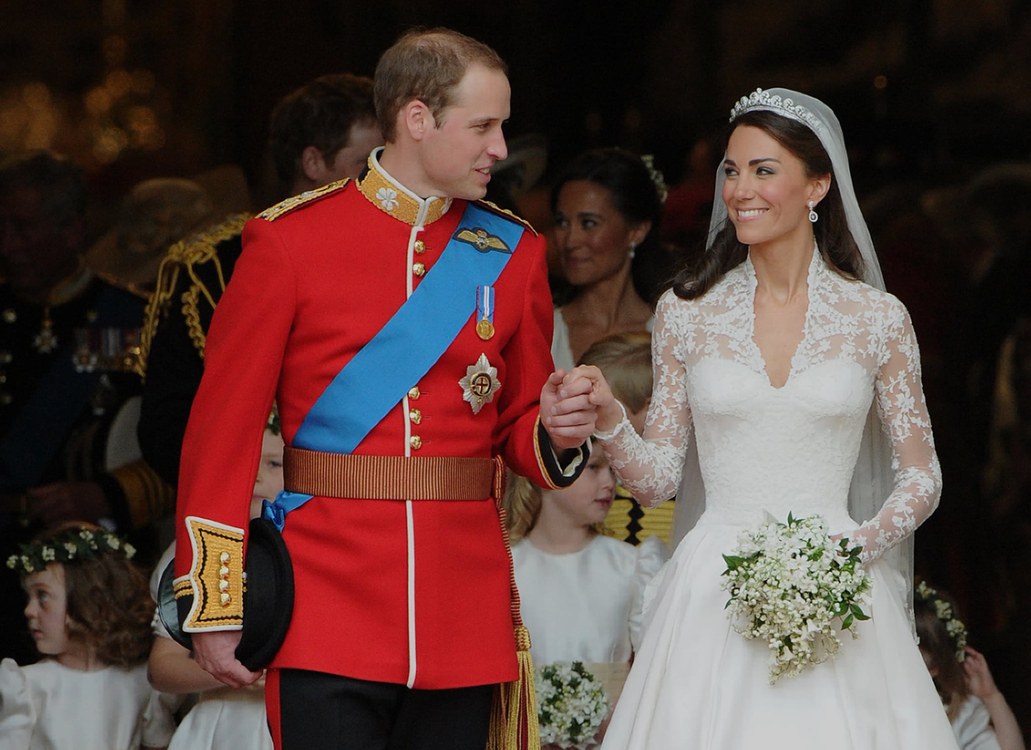 Britain's Prince William and his wife Kate, Duchess of Cambridge, look at each other as they come out of Westminster Abbey following their wedding ceremony, in London, on April 29, 2011. AFP PHOTO / CARL DE SOUZA (Photo credit should read CARL DE SOUZA/AFP/Getty Images)