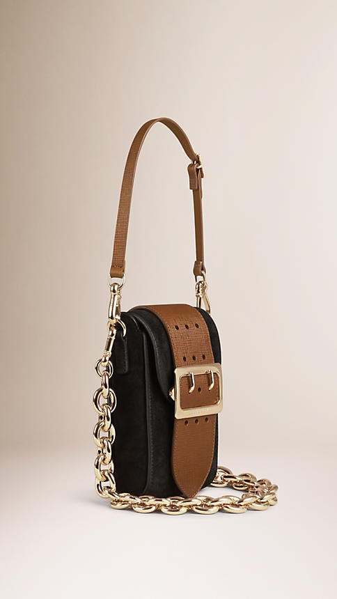 I've got a major obsession with the throw-on-and-go concept of Burberry's oblong buckle bag ($1,295). I tend to travel lightly, so I'll empty out my wallet and throw a few credit cards into this chainstrap design before heading out the door.
— SW