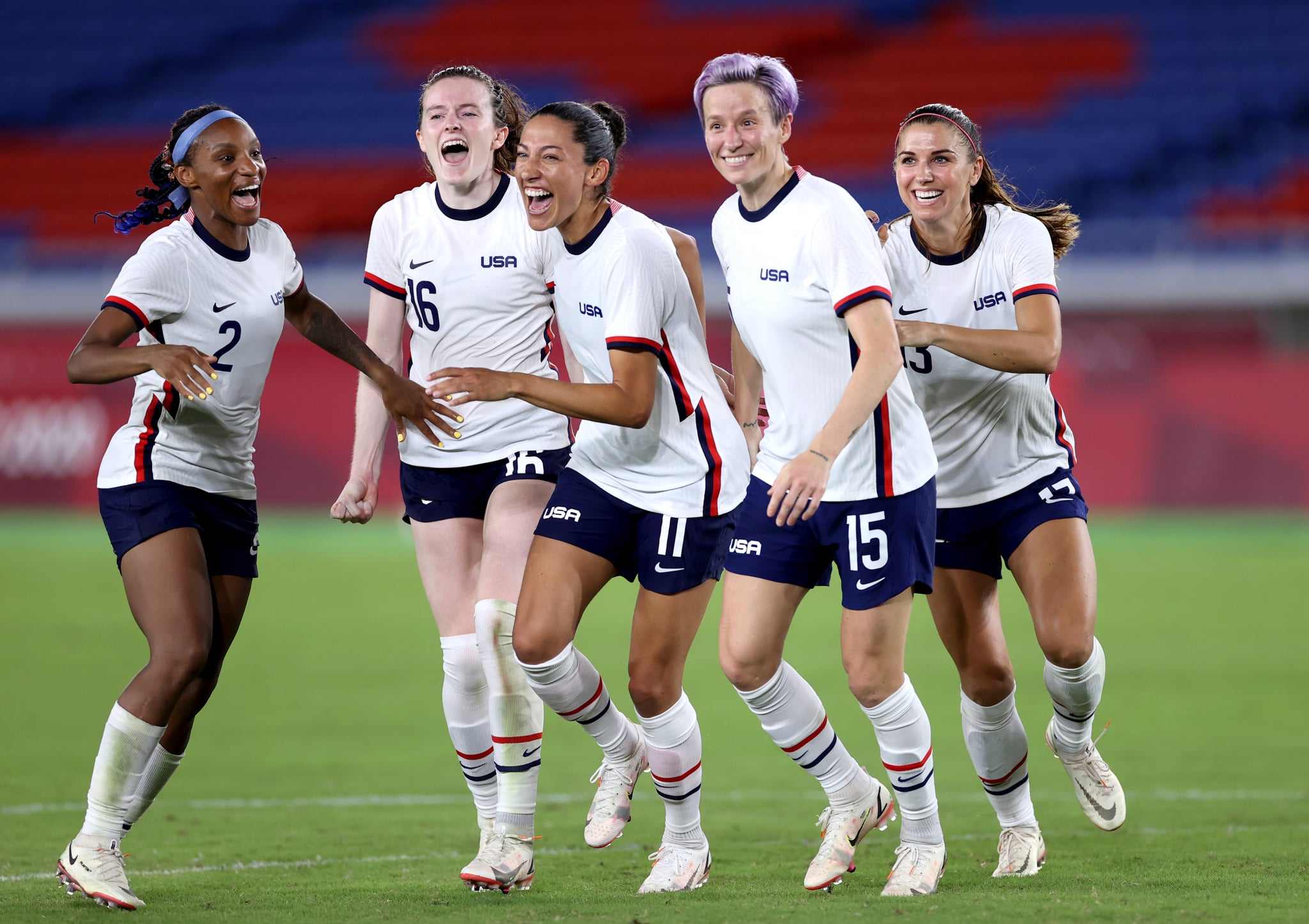 YOKOHAMA, JAPAN - JULY 30: Crystal Dunn #2, Rose Lavelle #16, Christen Press #11, Megan Rapinoe #15 and Alex Morgan #13 of Team United States celebrate following their team's victory in the penalty shoot out after the Women's Quarter Final match between Netherlands and United States on day seven of the Tokyo 2020 Olympic Games at International Stadium Yokohama on July 30, 2021 in Yokohama, Kanagawa, Japan. (Photo by Laurence Griffiths/Getty Images)