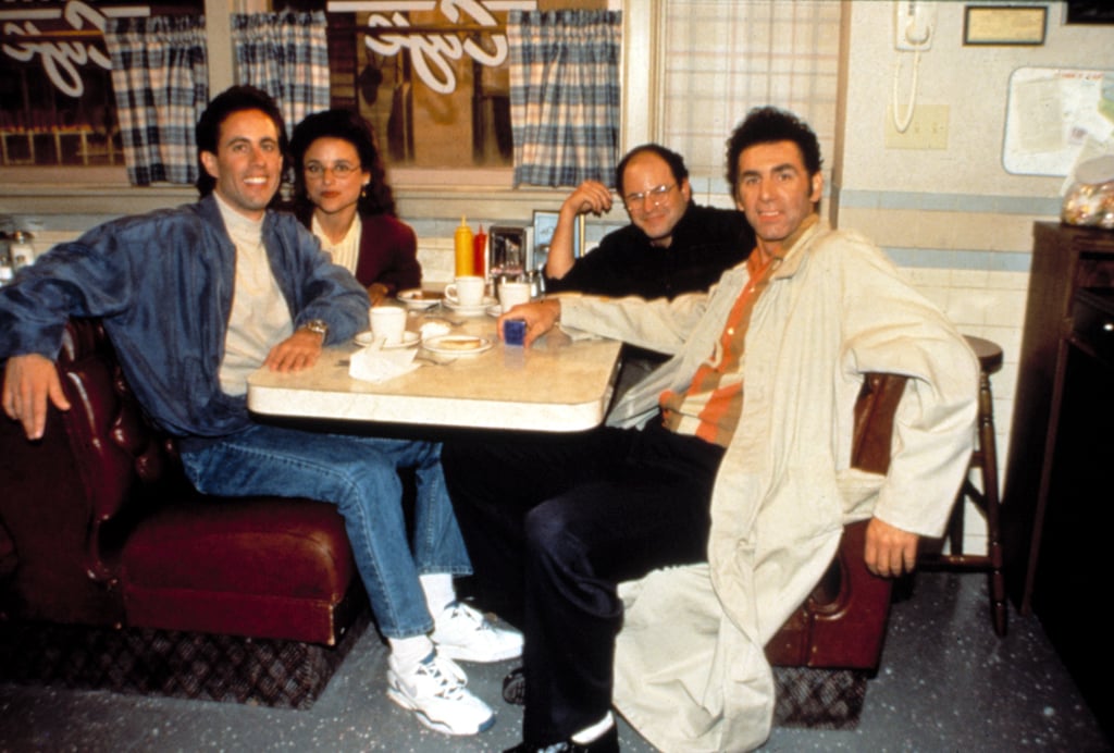 Who says you can't dress cool to hang in a diner? Take a cue from Jerry in Nikes, jeans, beige turtleneck, and a bomber jacket.