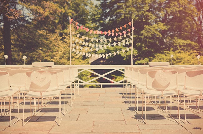 Delve into the popular ombré trend with layers of colored bunting in a variety of shades — simple, festive, and totally original.
Photo by Sweet Little Photographs via Green Wedding Shoes
