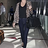 Miranda Kerr amped up her travel style with a leopard Stella McCartney cardigan ($1,128), glitter Miu Miu shades ($390), and her trusty Givenchy tote after touching down at LAX.