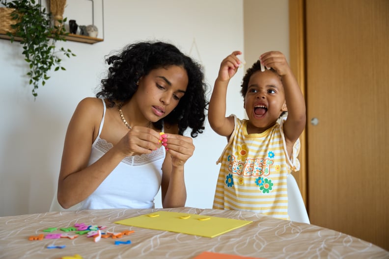 Young Mother and Daughter Doing Crafts at the Dining Table