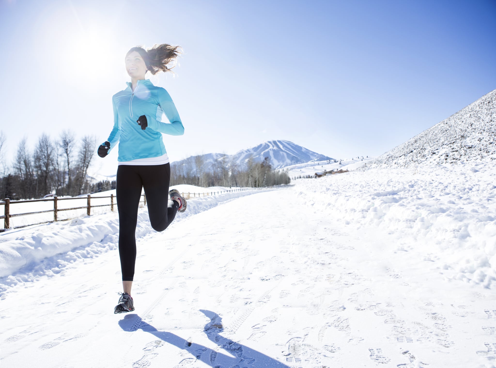 A woman jogging in Sun Valley on a beautiful winter day.