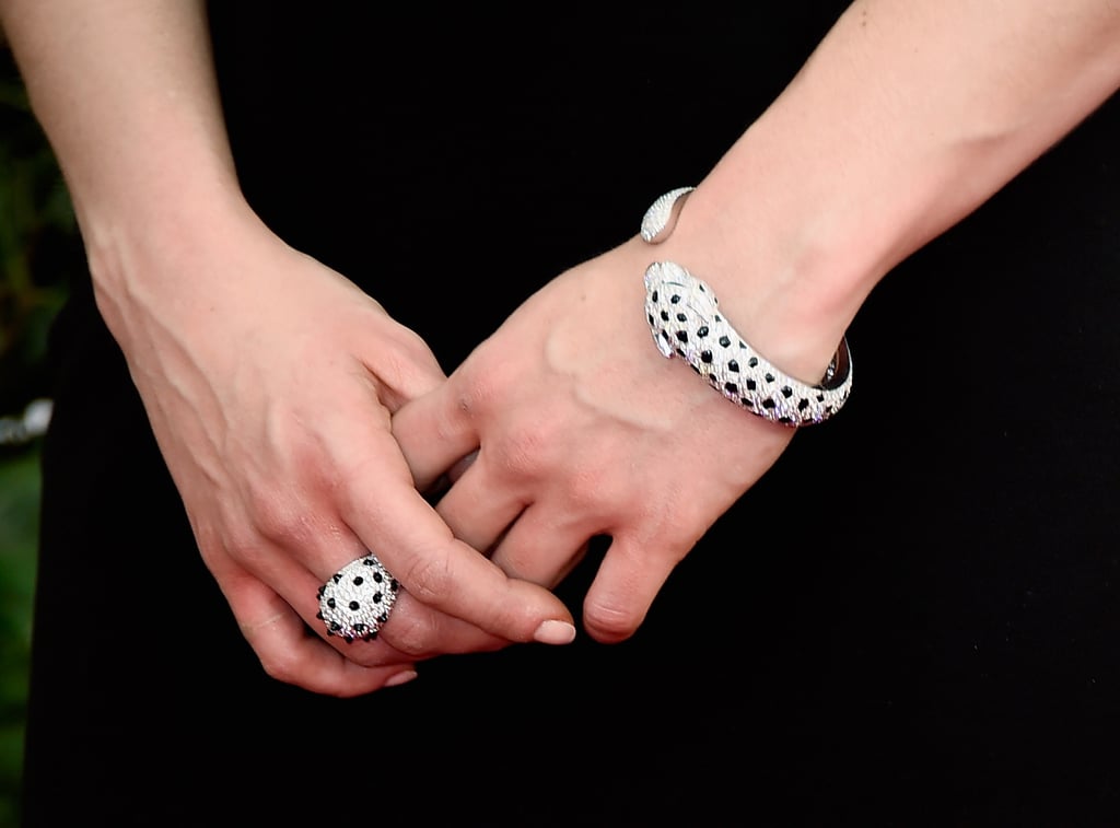 Game of Thrones actress Emilia Clarke complemented her sleek crisscross Donna Karan number  with matching Cartier jewels.