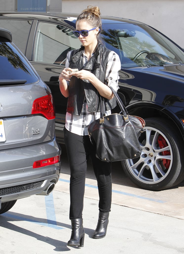 Jessica added a touch of edge to her black-and-white combo — a plaid Madewell top, black denim, and matching ankle booties — by layering a cropped leather vest while out in LA.