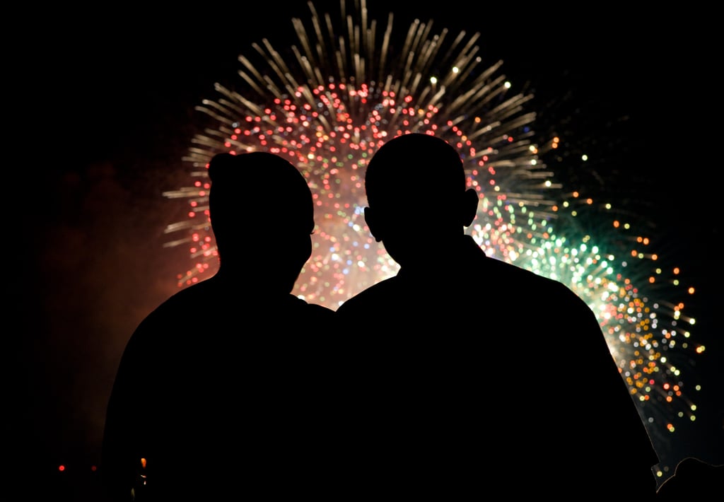 The first couple being illuminated by fireworks in DC on the Fourth of July.