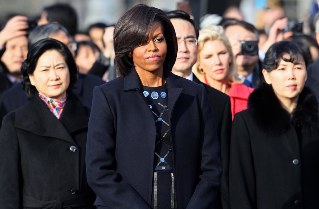 Wearing a beaded dress and wool coat while hosting Chinese President Hu Jintao in 2011.