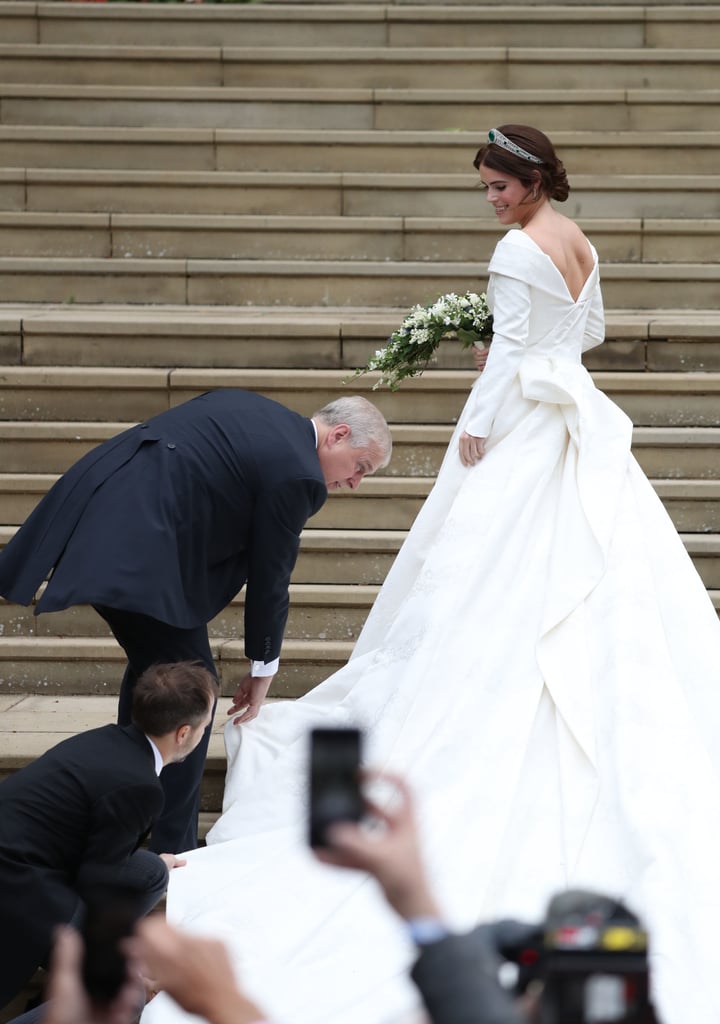 Andrew helped Eugenie with her gown while arriving at her wedding in Oct. 2018.