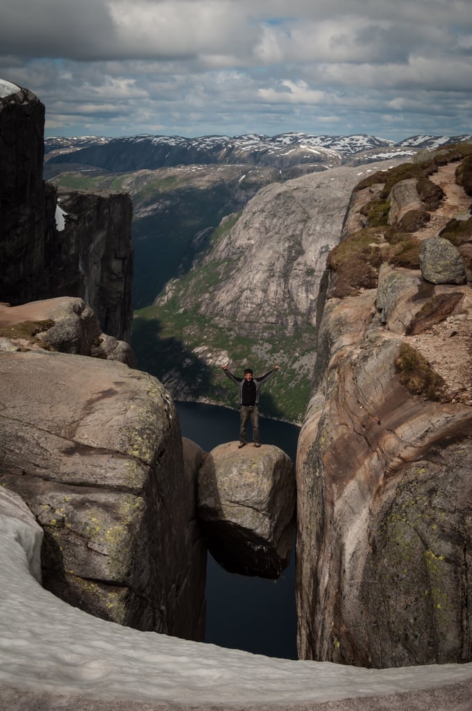 Stand on a Boulder Wedged Between Mountains in Norway Stand on a Boulder Wedged Between Mountains in Norway