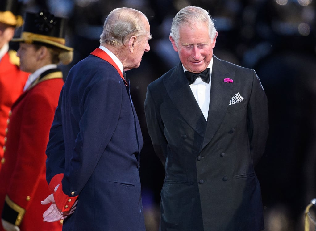 at 5'10," Prince Charles should stand below his father, but Philip's posture puts him at about the same height.