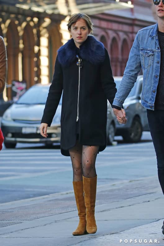 Dakota Johnson in black fur collar coat with brown Louis Vuitton