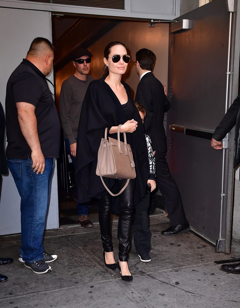 Who made Angelina Jolie's brown sunglasses and leather handbag