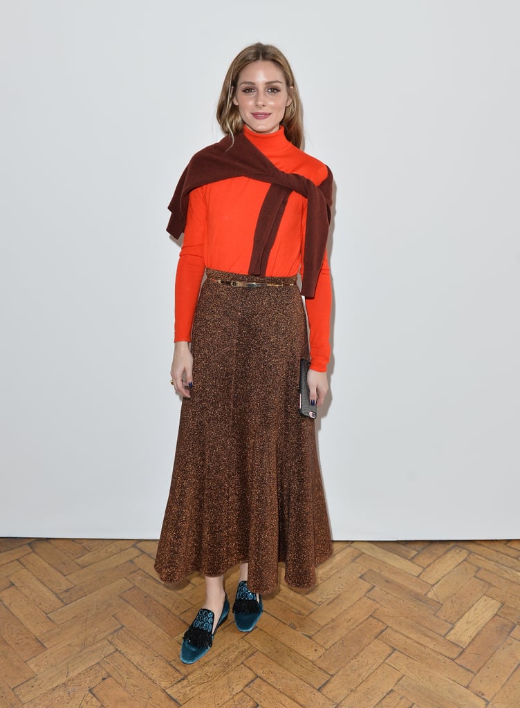 For Pringle of Scotland's show in London, we got preppy vibes from Olivia's midi skirt and sweater combo thanks to that extra sweater tied at the shoulders and a pair of embellished flats.
