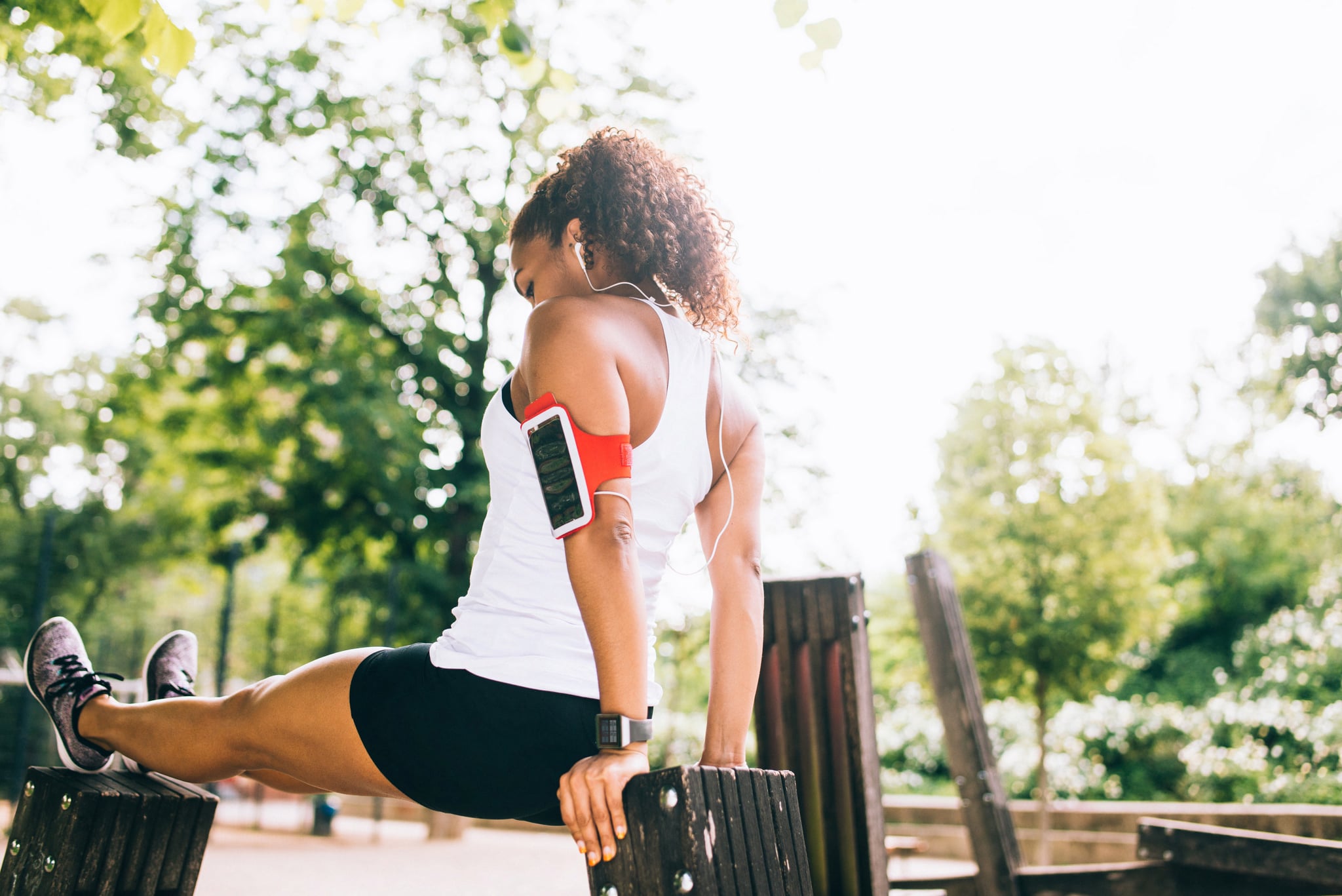 Woman doing dips outdoor.