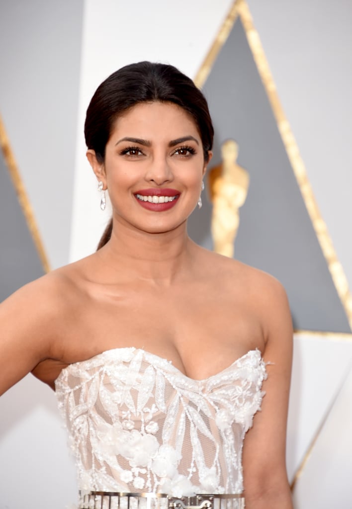 POPSUGAR: What is the best part of working with Priyanka?
Castillo: The best part is her overall attitude. She's been in the industry for a long time working in media, and she likes to have fun with her look. She doesn't want to be boring; she's always pushing my creativity to the next level and keeps me on my toes. That's a gift from a client because you don't want to get too comfortable in what you're doing.
PS: What was the getting-ready atmosphere like?
C: We were playing music — we were playing Zayn Malik’s "Pillowtalk" and Rihanna's "Work" on repeat. We both love the upbeat, top 40 music so it helps that we're on the same page. We love the popular songs like the new Coldplay and Beyoncé. We were both drinking lots of coconut water because we both have really long days going into really long weeks. We're each hopping on flights to the East Coast tonight to work tomorrow morning. Priyanka kept it very healthy today eating protein and veggies, in comparison to her usual In and Out Burger order.
PS: What inspired the hair for her Oscars look?
C: We wanted to change it up from what we usually do, especially what we've done this awards season, and we took a risk that worked out really well. We usually do a high/tight ponytail and a side part so we did the opposite — a low, loose pony with a middle part. As a hair artist, I get inspired by the dress, especially with this dress baring the shoulders and the opulent earrings. We wanted to do an effortless glam look as a team but something that would sustain the whole night. The dress and the jewelry stand alone and we didn't want to compete with them.
