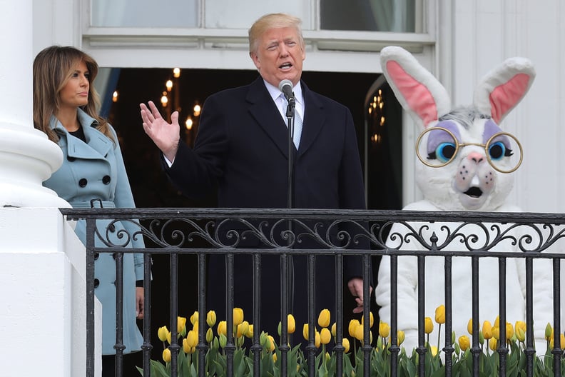 WASHINGTON, DC - APRIL 02:  (AFP OUT) U.S. President Donald Trump (C) delivers remarks from the Truman Balcony with first lady Melania Trump during the 140th annual Easter Egg Roll on the South Lawn of the White House April 2, 2018 in Washington, DC. The 