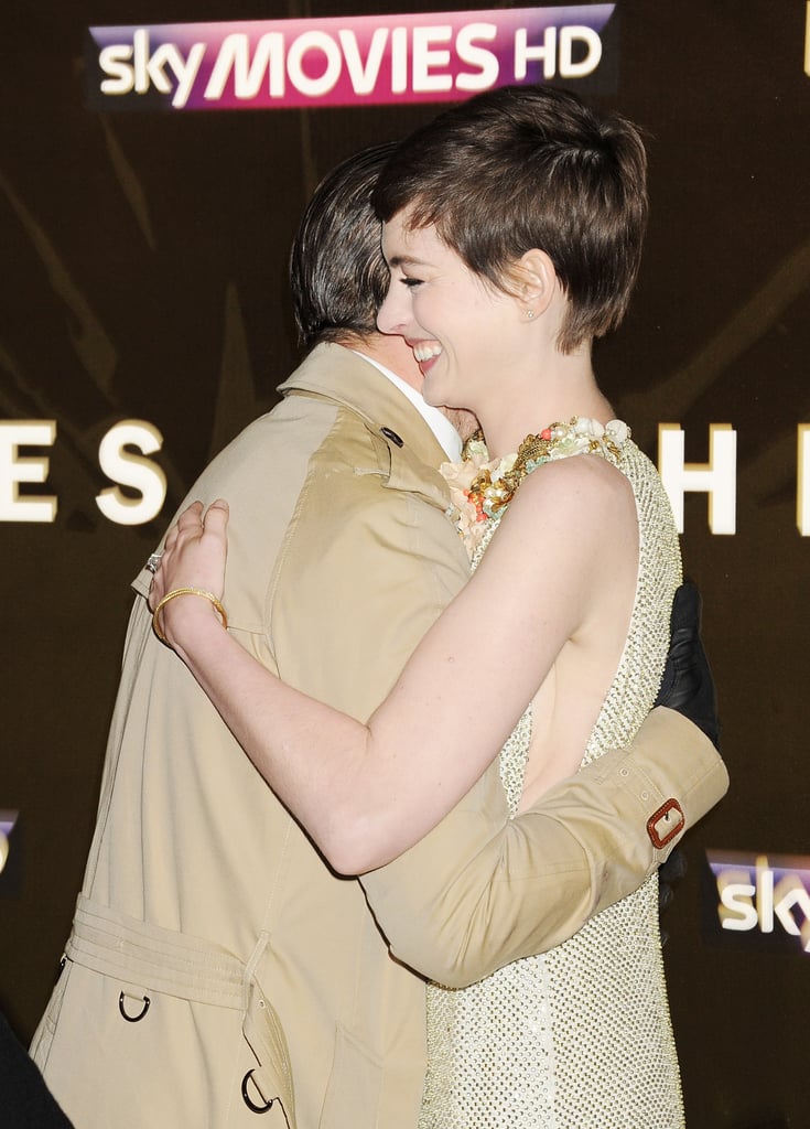 Hugging Anne Hathaway at The Dark Knight Rises' London premiere in 2012.