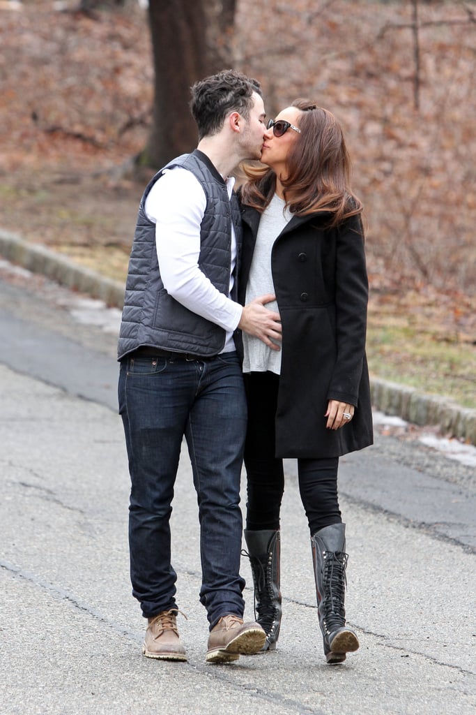 Kevin Jonas kissed his wife, Danielle Jonas, in New Jersey on Wednesday while holding her pregnant belly. Aww!