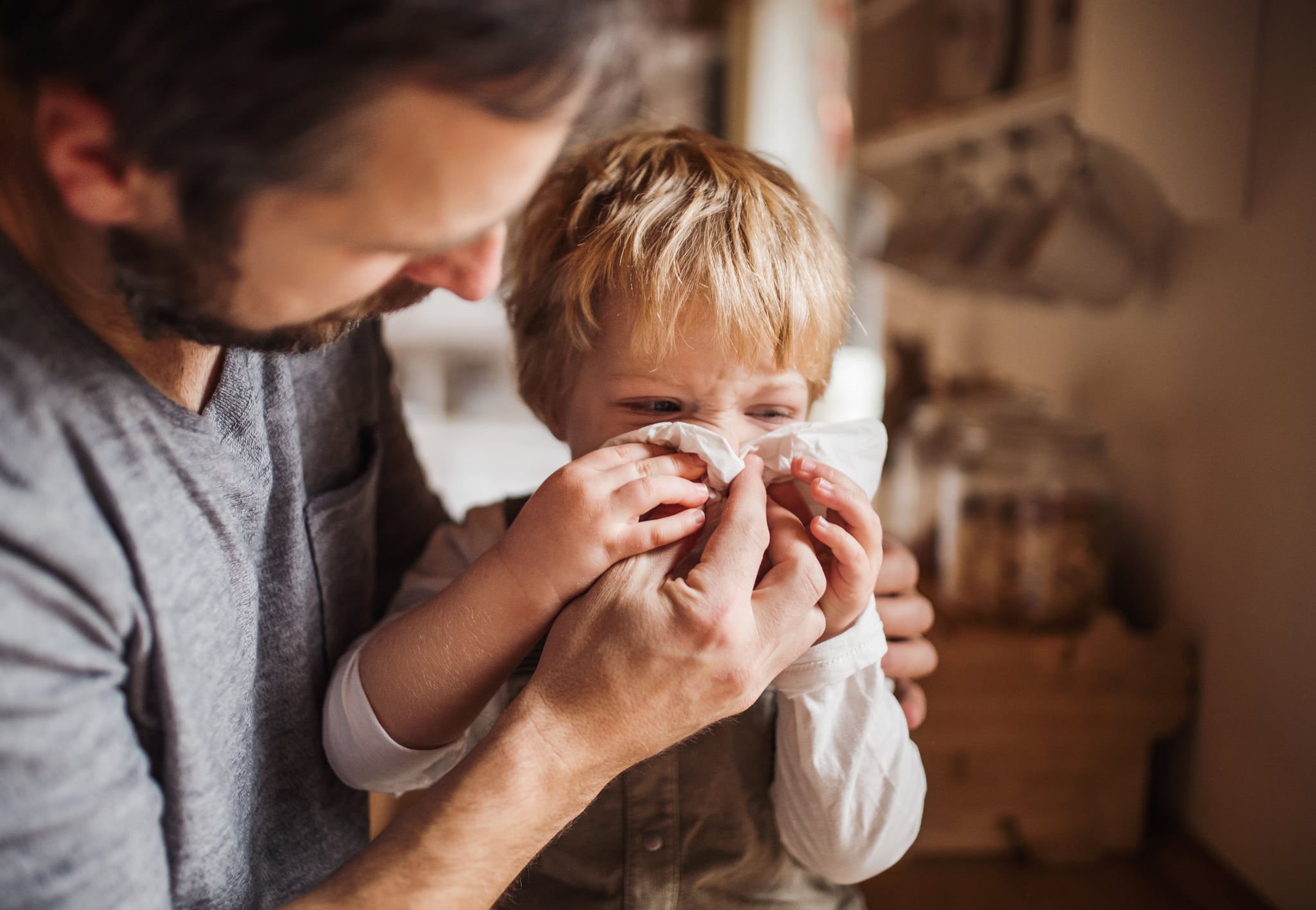 A man with a boy standing at home.