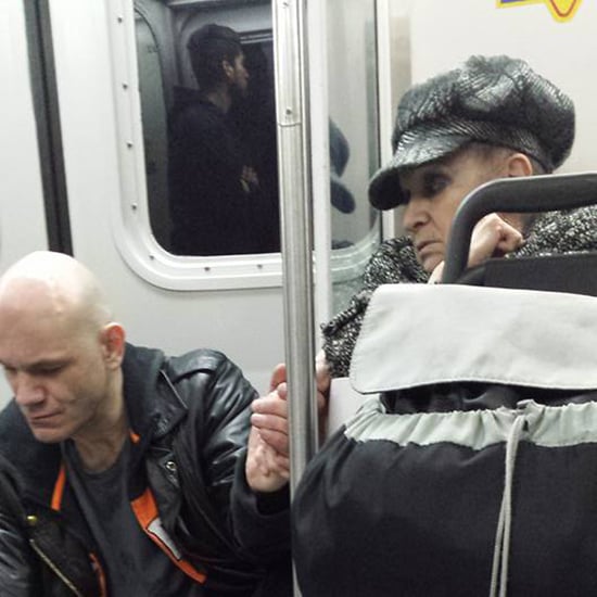 Woman Holds Man's Hand on the Train