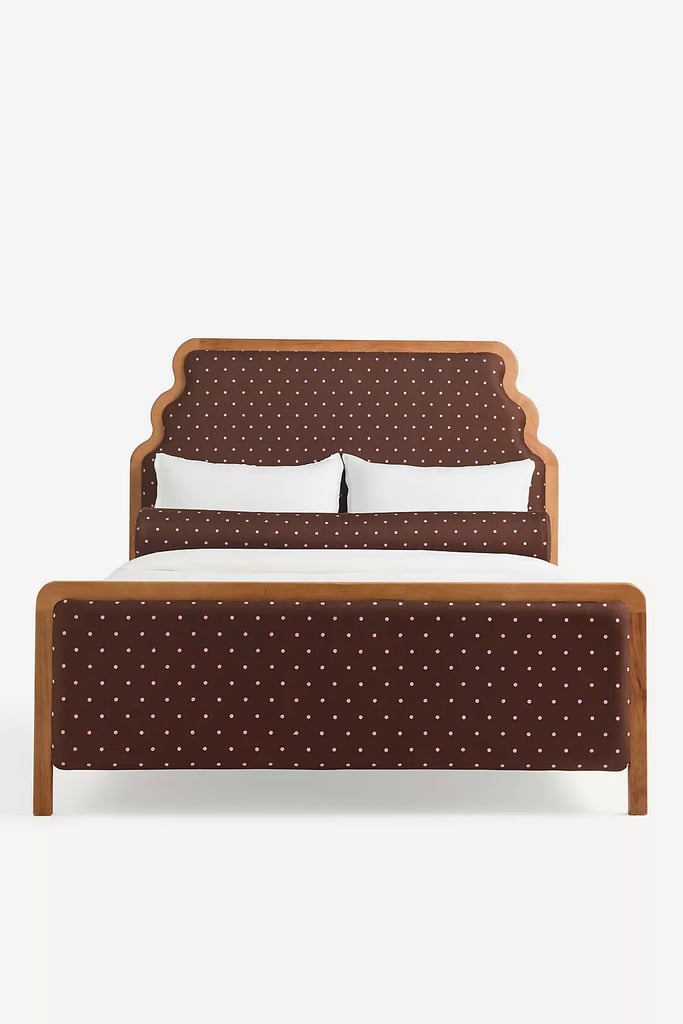 Anthropologie Pim Evelyn Bed ($2,298)
Obsessed with the polka-dot trend? This adorable bed frame adds a playful accent to any bedroom. From the wavy wooden headboard to the rich maroon fabric, it feels equal parts cozy and sophisticated. 
What we love:

The perfect mix of wood and fabric, this bed frame adds just the right amount of texture and warmth to a space.

Who it's best for:

Someone who wants their bed frame to double as a statement piece.

Who should avoid it:

If you're looking for an apartment or small-space-friendly design, the limited sizing may not be ideal. 

The Details: Material: Oak and polyester | Sizes: Queen and king