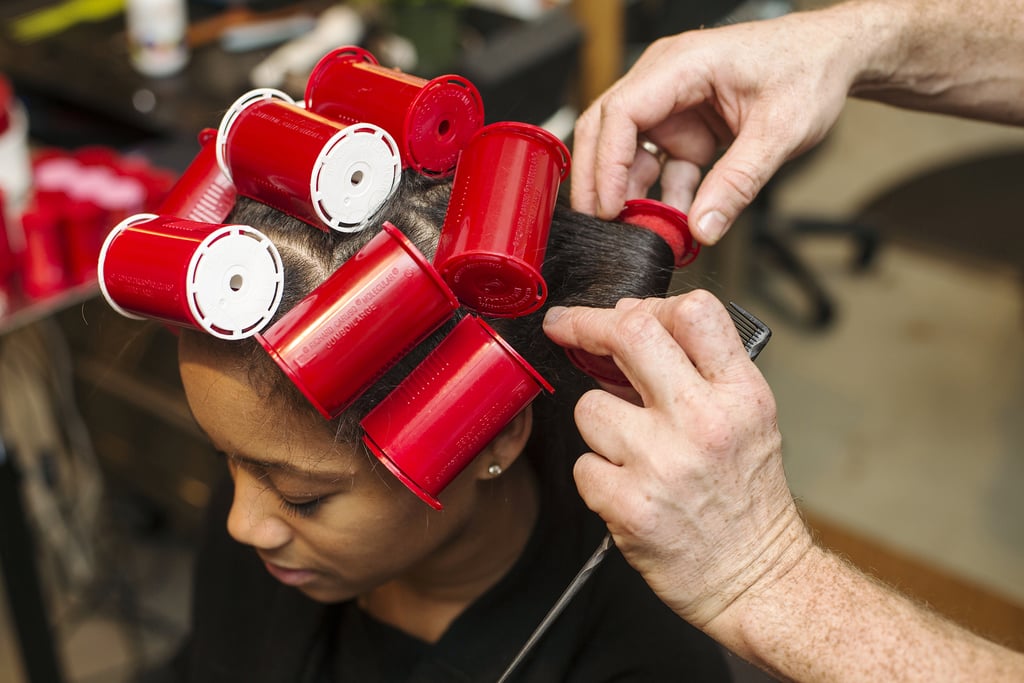 Roll one-inch sections around the sponge rollers, ensuring the hair is curled under. Let sit for 20 minutes to an hour before removing. The longer the better, but Dickey warned against sleeping in the rollers, which can lead to breakage. You can also sit under a cool hood dryer while you wait to enhance shine.