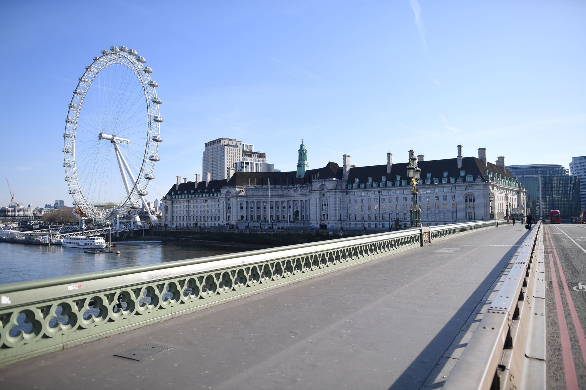 A picture shows a quiet Westminster Bridge with the London Eye in the background in central London in the morning on March 24, 2020 after Britain ordered a lockdown to slow the spread of the novel coronavirus. - Britain was under lockdown March 24, its population joining around 1.7 billion people around the globe ordered to stay indoors to curb the 