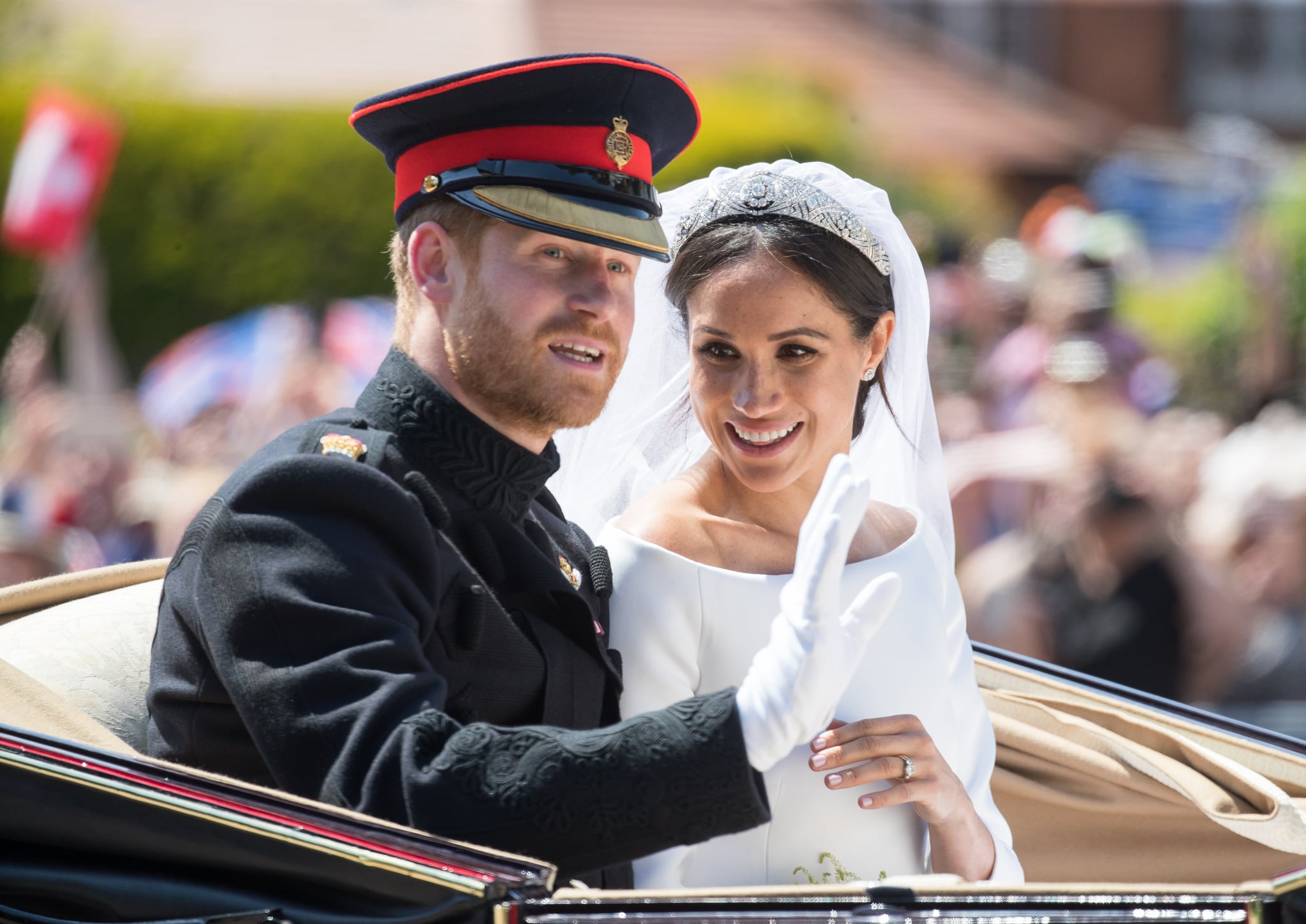 WINDSOR, ENGLAND - MAY 19:  Prince Harry, Duke of Sussex and Meghan, Duchess of Sussex ride by carriage following their wedding at St George's Chapel, Windsor Castle on May 19, 2018 in Windsor, England. Prince Henry Charles Albert David of Wales marries Ms. Meghan Markle in a service at St George's Chapel inside the grounds of Windsor Castle. Among the guests were 2200 members of the public, the royal family and Ms. Markle's Mother Doria Ragland.  (Photo by Pool/Samir Hussein/WireImage)