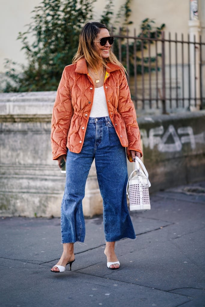 The perfect transitional outfit: cropped wide-leg jeans, a quilted jacket, and sandals.