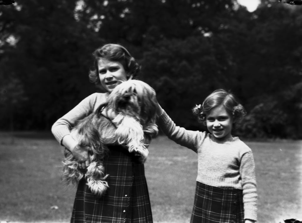 Aww! Elizabeth and Margaret posed with their dog Chu-Chu at the Royal Lodge in 1936.