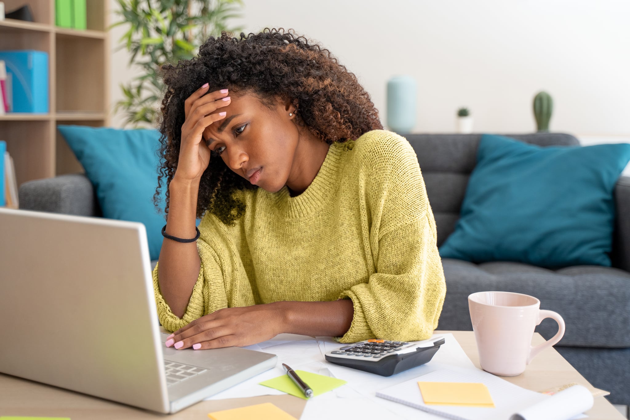 Stressed black woman working at home alone