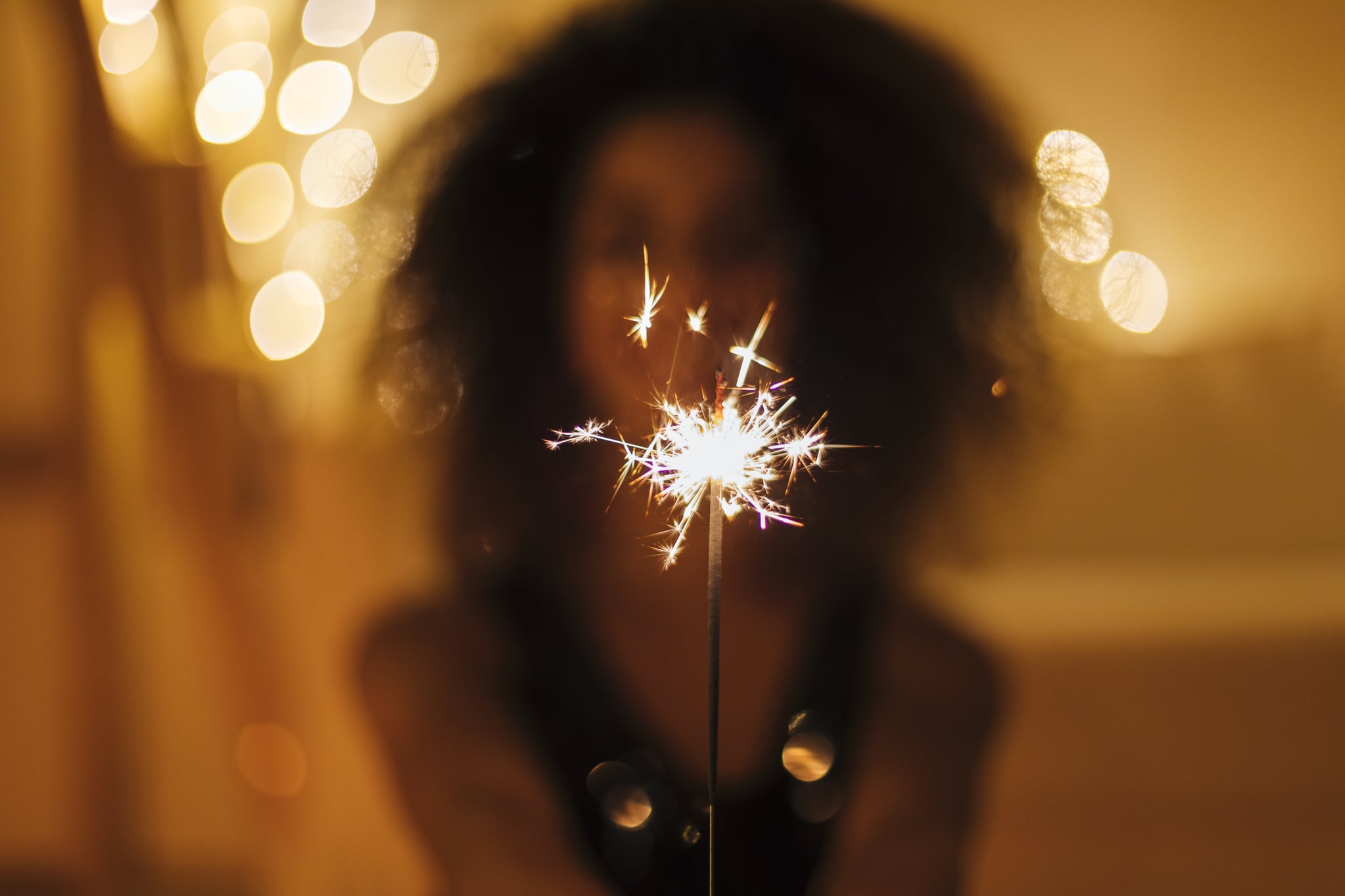 Girl holds Christmas sparkles