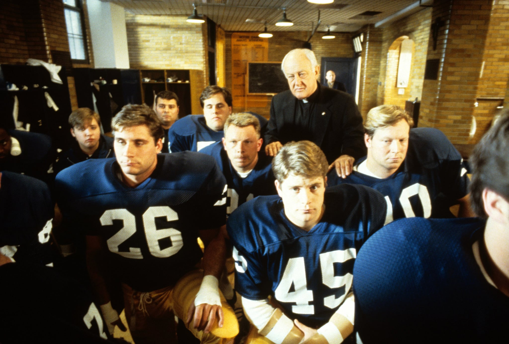 RUDY, Sean Astin (centre right), Father James Riehle (back), 1993, TriStar Pictures/courtesy Everett Collection