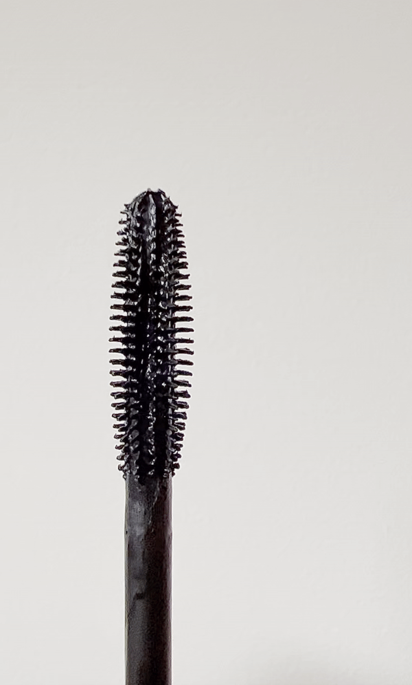 The wand of the Tower 28 MakeWaves Mascara with a curve like structure with silicone bristles.