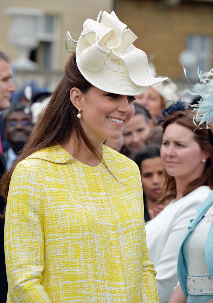 Kate topped her sunny coat with a Jane Corbett hat at garden party in 2013.
