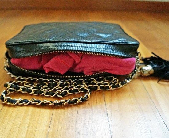 Stuff clothing into purses.