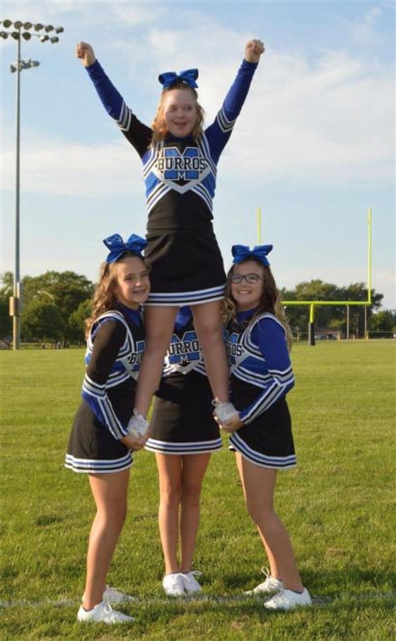Despite the setback, it's been smooth sailing for Audrey ever since she joined the Mokena Burros junior varsity cheerleading team, an inclusive recreational program 30 miles outside of Chicago, IL. 
Along with all the new friends she's made, the 13-year-old has also learned important lessons about teamwork and setting goals. 
"She absolutely learned what it means to be part of a team that loves and trusts each other," said Jody. "That friends can be counted on when fear takes over.  She learned how to set goals and reach them even when they seem unattainable. For example, she wanted to be a flyer but needed a strong core. She worked hard, stayed true to her goal and the coach put her in the center of the routine as a flyer."