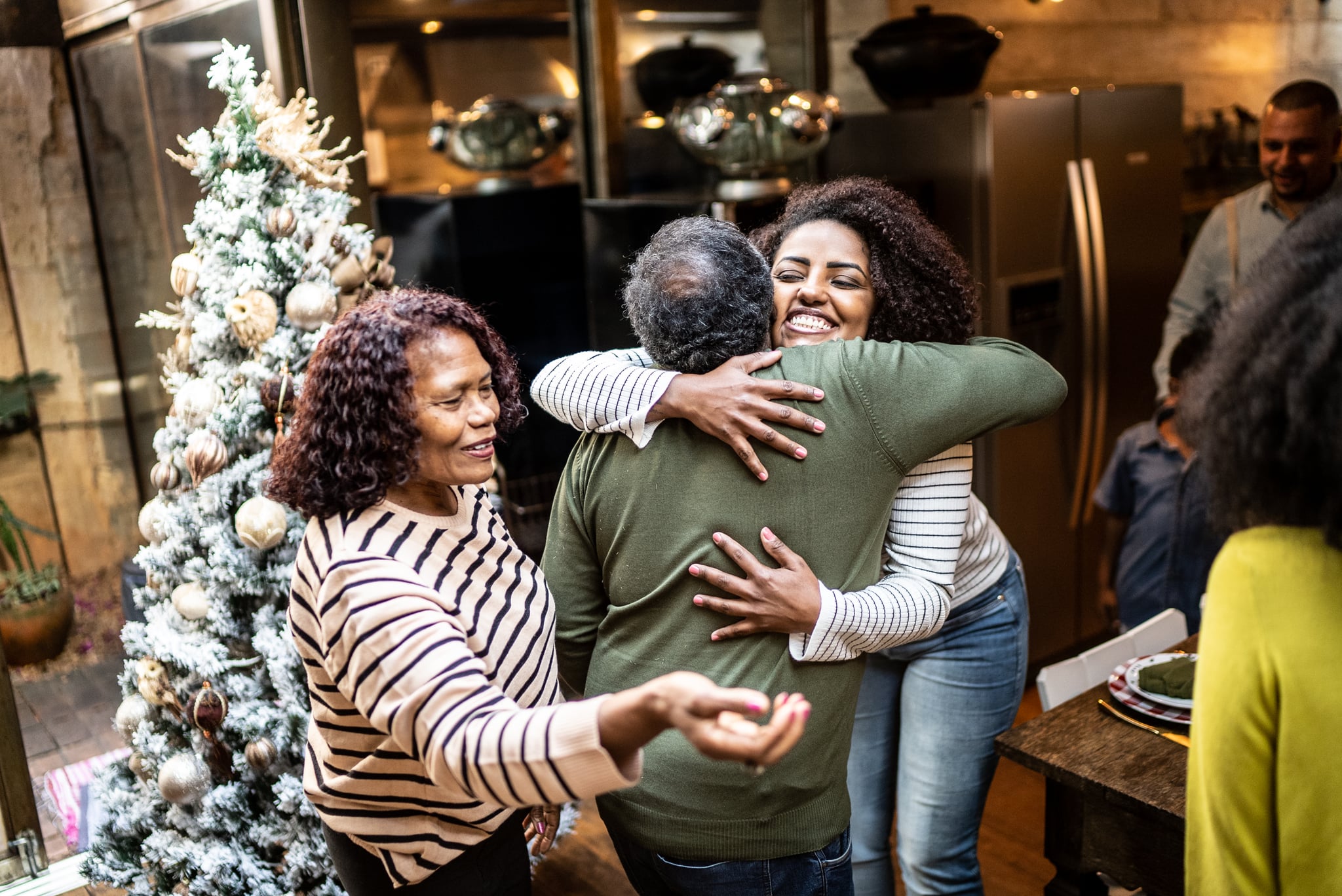 Woman embracing father on Christmas time at home