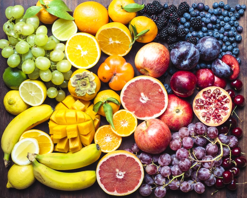 A colourful spectrum of fruit: oranges, lemons, limes, mandarins, grapes, plums, grapefruit, pomegranate, persimmons, bananas, cherries, apples, mangoes, blackberries and blueberries.