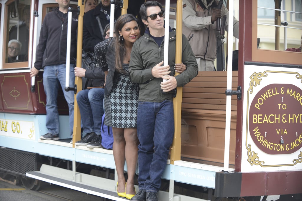 They hop on a cable car while touring around San Francisco.