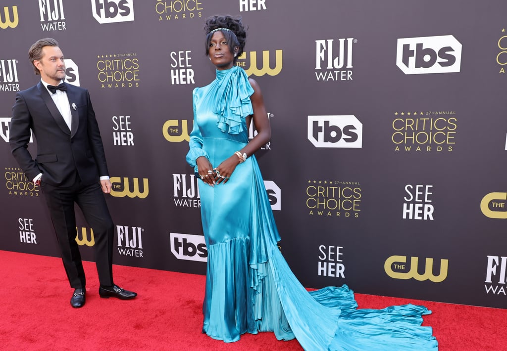 Jodie Turner-Smith attended the Critics' Choice Awards on Sunday in a Gucci dress made of teal silk satin with a cascading ruffle skirt. Beautifully tailored, the asymmetrical gown featured a puff sleeve to the right and an oversize ruffle detail across Turner-Smith's left shoulder. 
Turner-Smith kept the ethereal theme going with a pair of leather platform sandals; emerald and diamond jewelry by Bulgari, including a snake bracelet; and a silver headpiece embellished with emeralds. 
The actor attended the awards show alongside her husband, Joshua Jackson, who wore a Gucci satin shawl-lapel tuxedo with a satin bow tie, a white evening shirt, and loafers. Take a moment to view Turner-Smith's gown from all angles here.

    Related:

            
            
                                    
                            

            Selena Gomez&apos;s Critics&apos; Choice Awards Ponytail Is Simplicity at Its Finest
