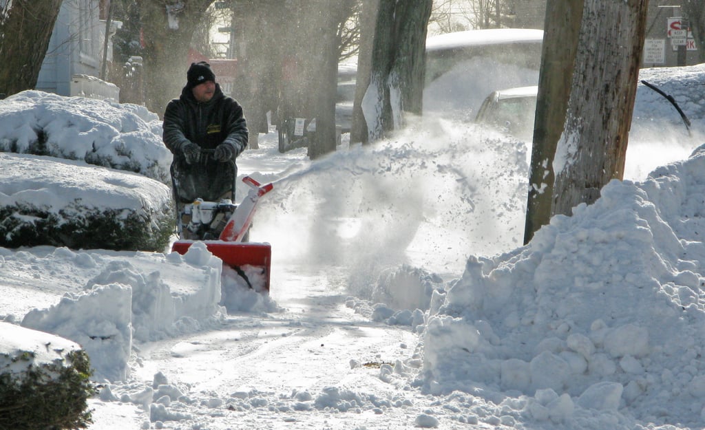 In the Bronx, a man cleared the sidewalk, leaving giant piles of snow in his wake.