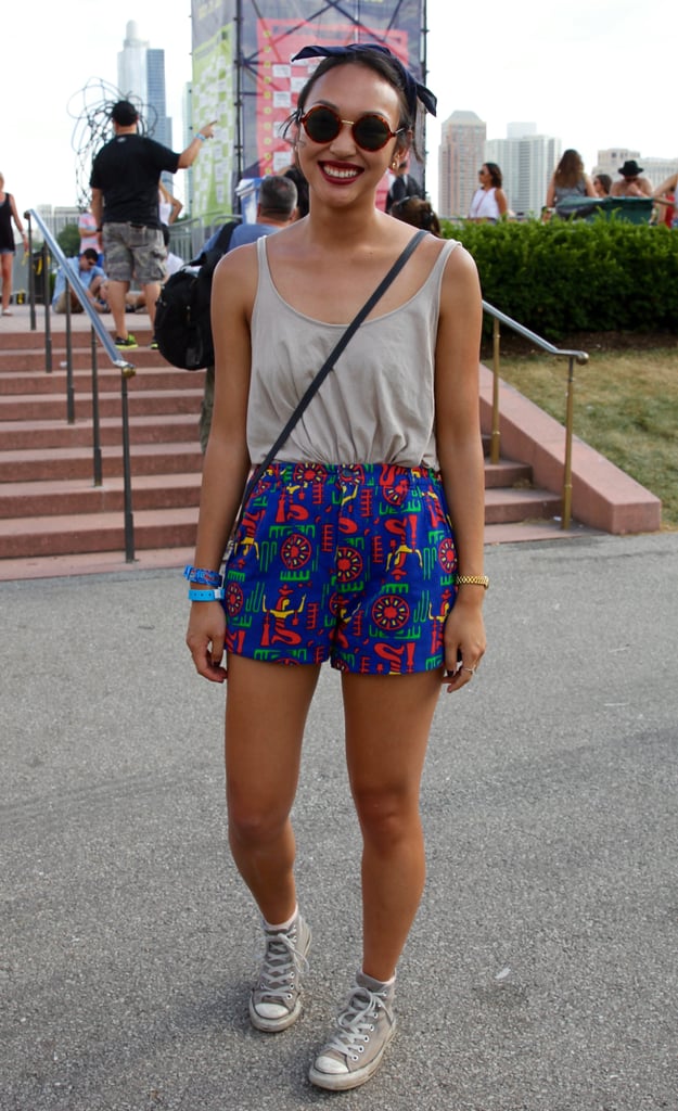 This music fan dressed to have fun, pairing a flouncy tank with playful shorts. Her circle-frame sunglasses and bandana hair tie were perfect accessories.