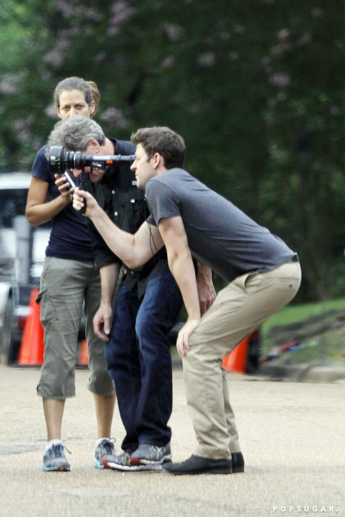 On Friday, John Krasinski looked comfortable behind the lens while directing his upcoming movie, The Hollars, in Jackson, MS.